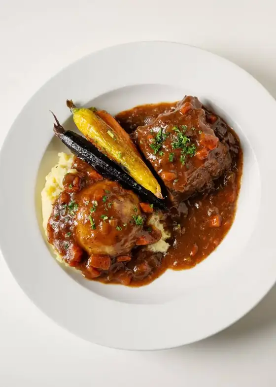 Red wine braised short rib over mashed potatoes with roasted carrots